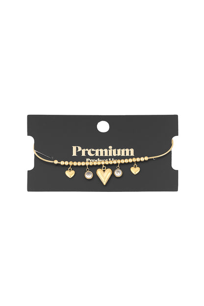 Gold heart bead bracelet displayed on black card packaging with Premium branding