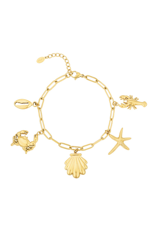 Gold-tone charm bracelet with ocean-themed charms including crab, seashell, starfish, lobster, and cowrie shell on a white background