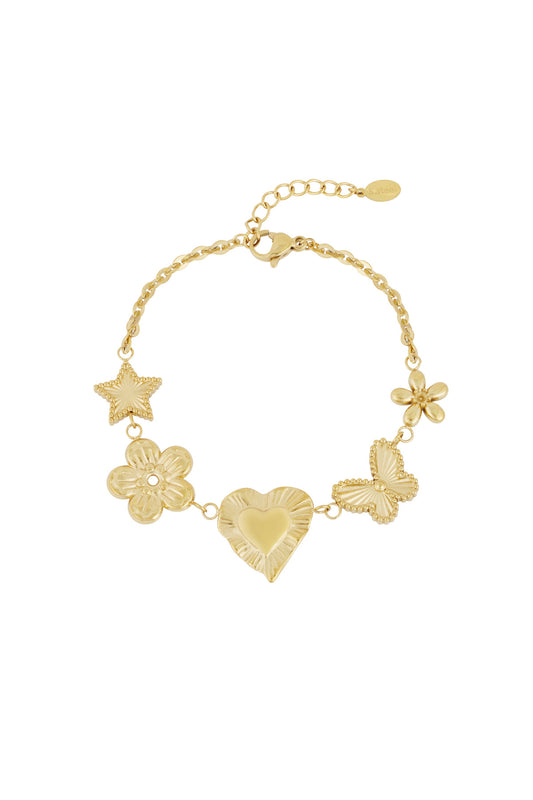Gold charm bracelet with star, flower, heart, butterfly, and blossom motifs on white background