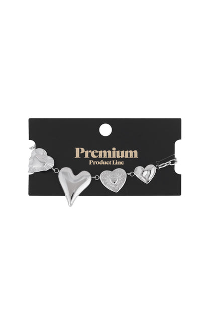 Silver chunky heart charm bracelet displayed on a black 'Premium Product Line' card packaging