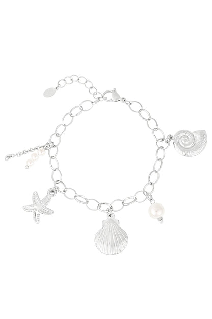 Sculpted Muse silver charm bracelet with seashell, starfish, and pearl charms on a delicate oval-link chain.