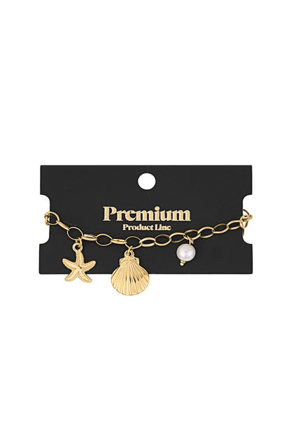 Gold charm bracelet displayed on black premium product line card