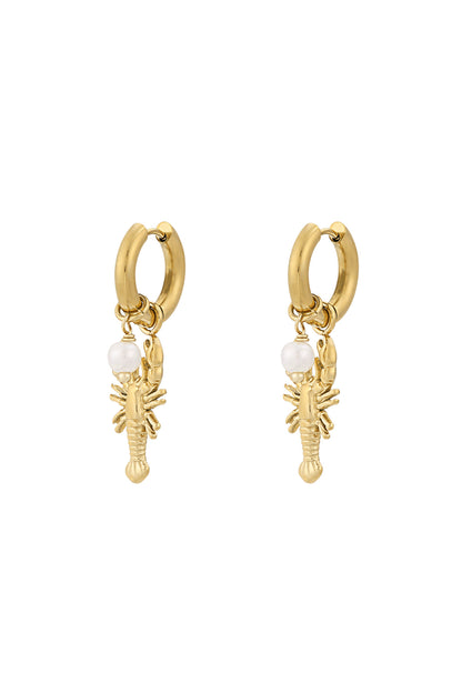 Pair of gold lobster charm drop earrings with small pearl detail on white background