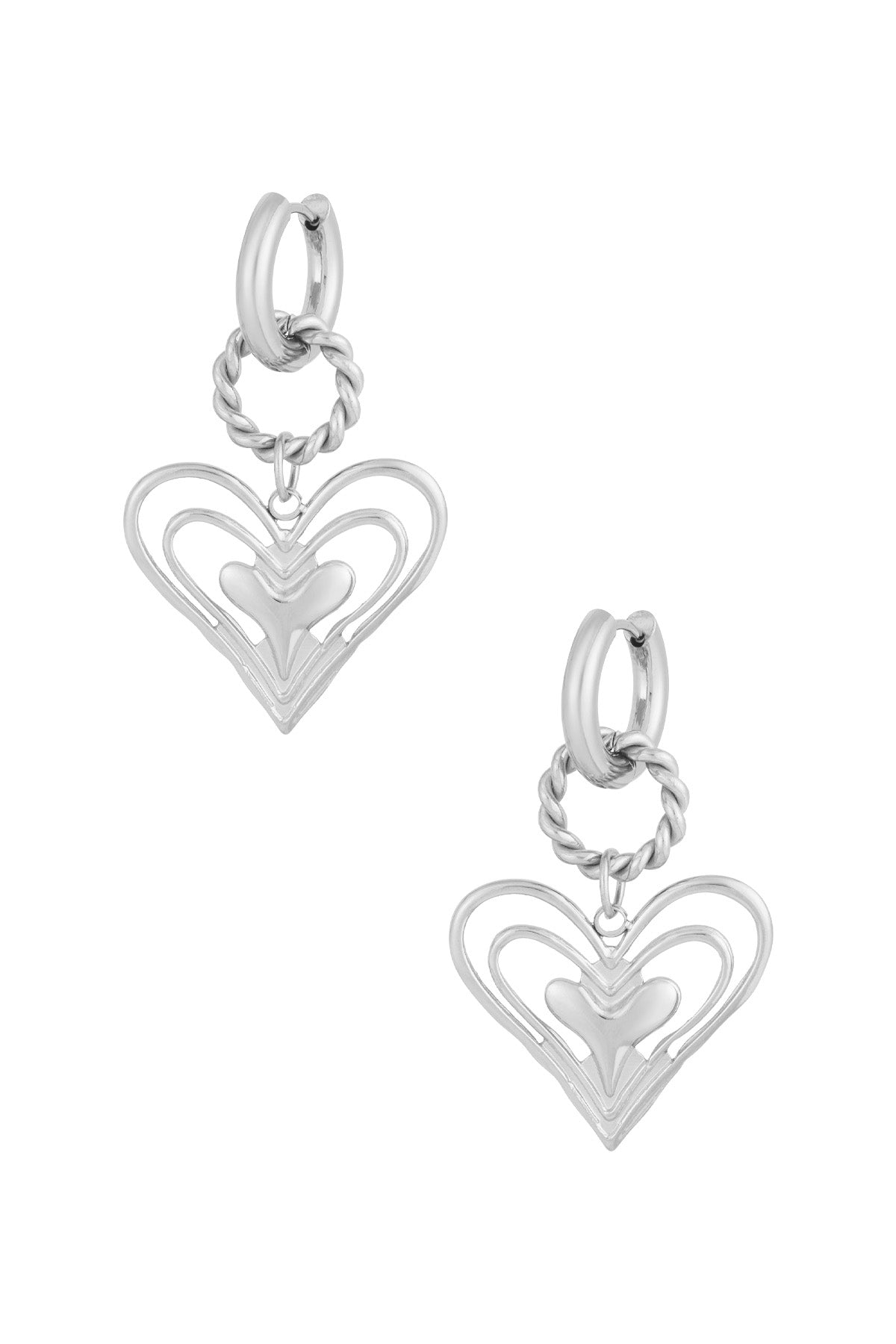 Silver twisted hoop earrings with layered open heart charm on white background