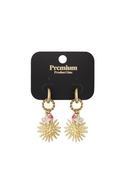 Gold-tone drop earrings displayed on premium black earring card with sun charm, enamel flower, and pink bead details.