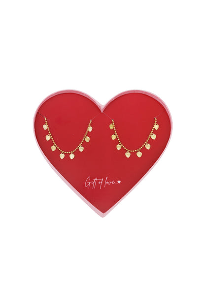 Set of two gold-coloured heart charm bracelets displayed in a red, heart-shaped box with the words 'Gift of love...' printed inside