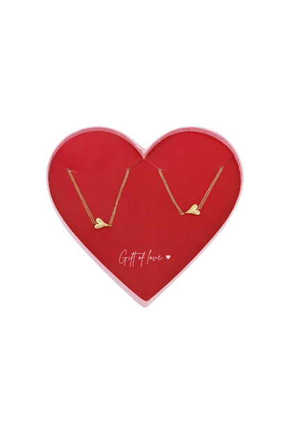 Dual gold-tone heart bracelets displayed inside a red heart-shaped gift box with 'Gift of love...' text