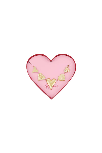 Gold heart charm bracelet with five distinct heart-shaped charms displayed inside a pink heart shaped box with red edges and the phrase 'Gift of Love'