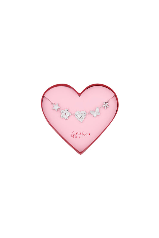 Silver stainless steel bracelet with star, flower, heart, butterfly, and flower charms in a pink heart-shaped box with red edge and 'Gift of love' text