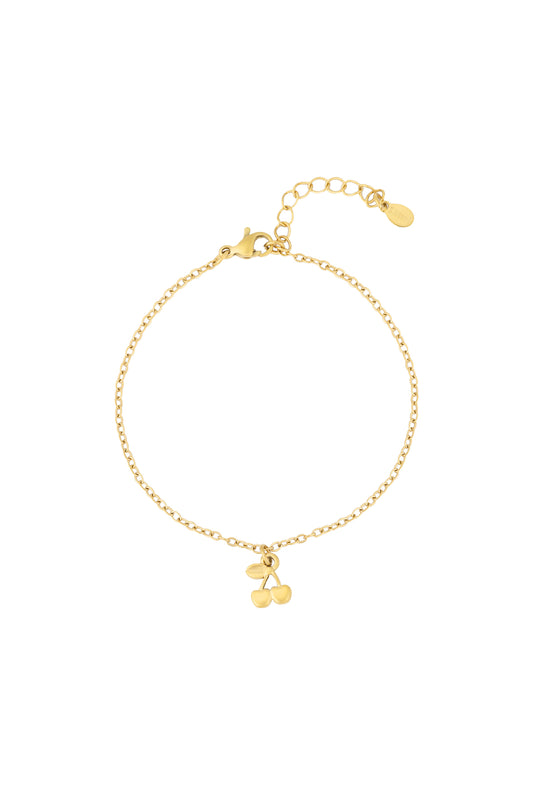 Close-up of golden cherry charm bracelet with delicate chain and adjustable clasp on white background