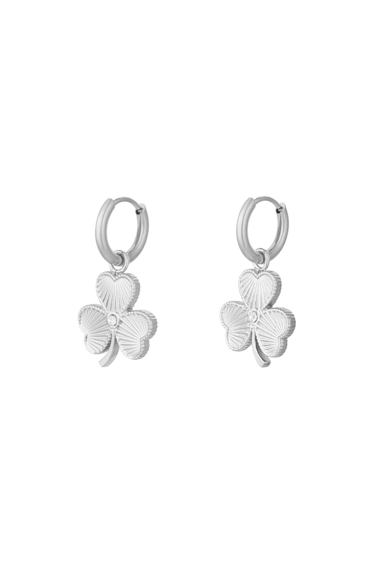 Pair of silver clover charm hoop earrings with textured leaves and crystal center