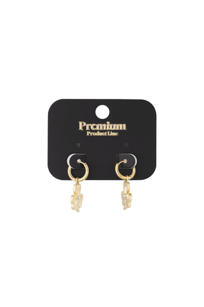 Gold clover charm hoop earrings displayed on black Premium Product Line card