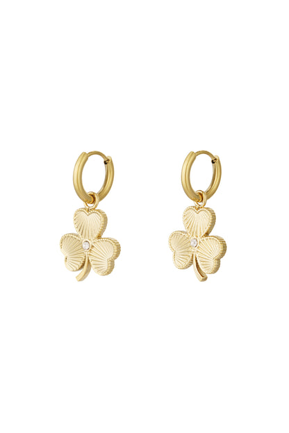 Gold clover charm hoop earrings isolated on white background with detailed texture