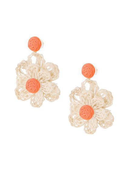 Pair of handcrafted flower-shaped earrings with natural raffia petals and bright orange woven centers on white background