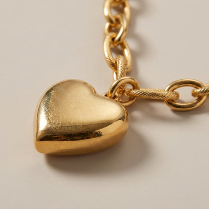 Gold-tone Heart Melter pendant necklace featuring a smooth, puffed heart charm on a textured cable chain.