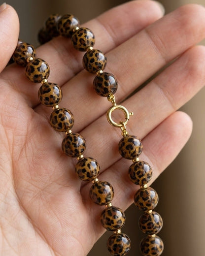 House Of Lily's beaded necklace features round brown and black leopard print beads on a gold-tone clasp.