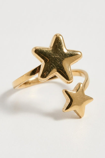 Gold wrap-around ring featuring one large star and one smaller star at the open ends.