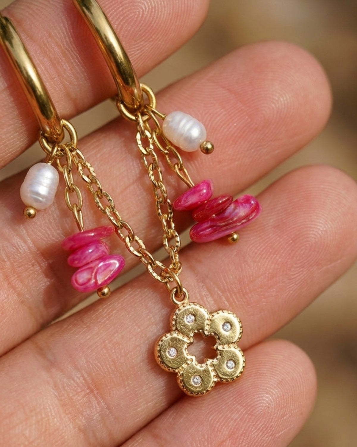 Chic Gold Bead Earrings featuring gold hoops with dangling chains, pink stone chips, white pearls, and flower charms.