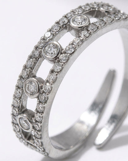 Silver ring with two parallel crystal-pave bands connected by circular bezels holding single round crystals.