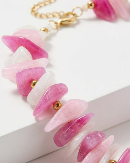 Multi-stone bead necklace with irregular pink, white, and clear stone chips separated by small gold beads.
