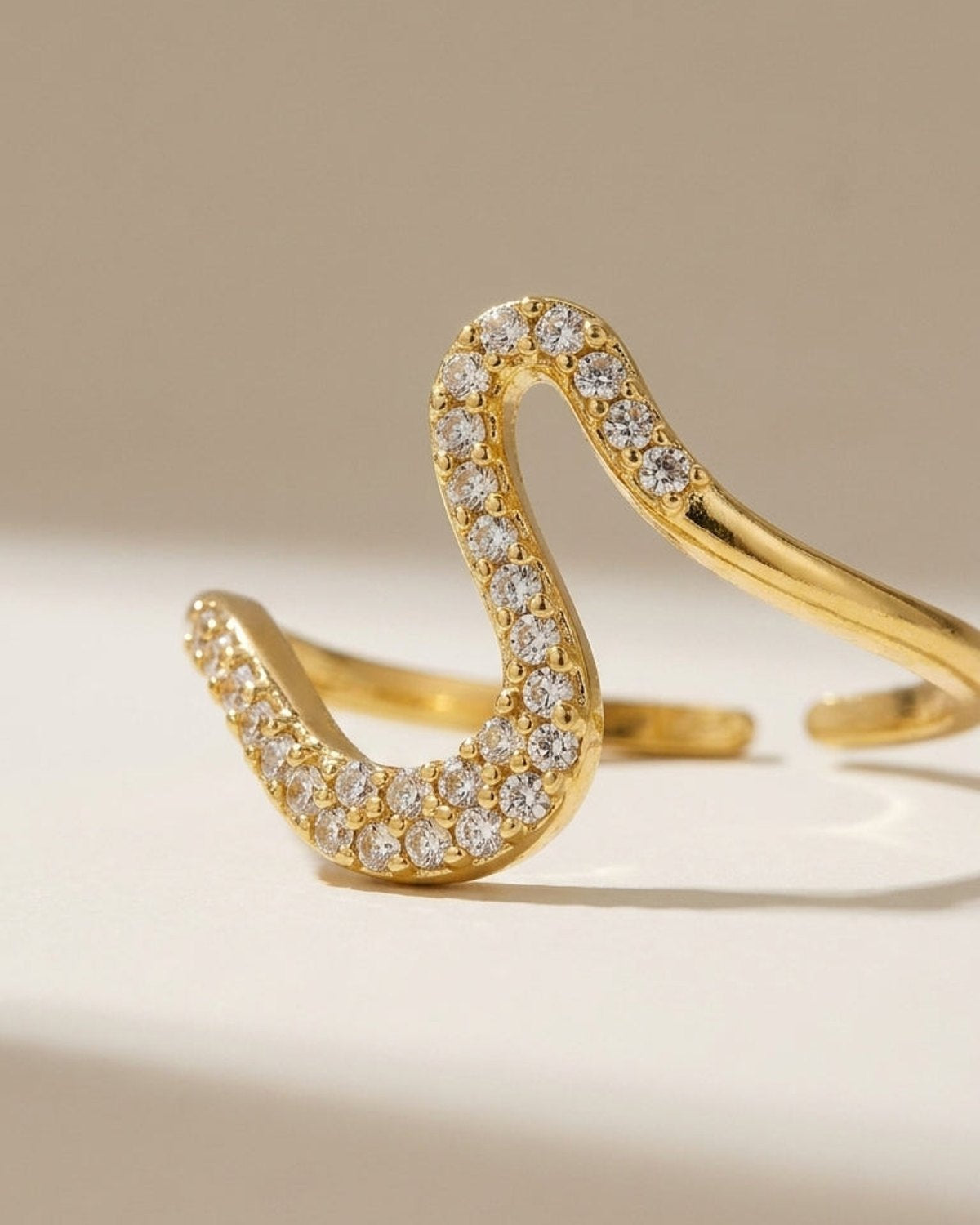 Gold Rhinestone Line Ring with an abstract, wavy open band paved in clear rhinestones.