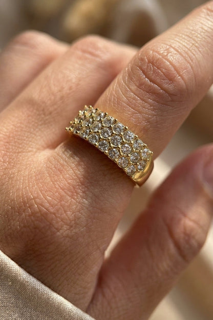 Gold ring featuring three parallel rows of pavé-set rhinestones.