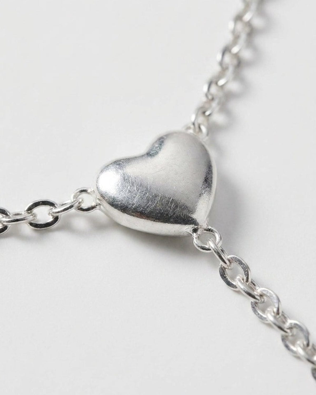 Radiant Heart Drop silver necklace with a puffed heart pendant on a delicate chain.