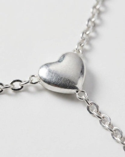 Radiant Heart Drop silver necklace with a puffed heart pendant on a delicate chain.