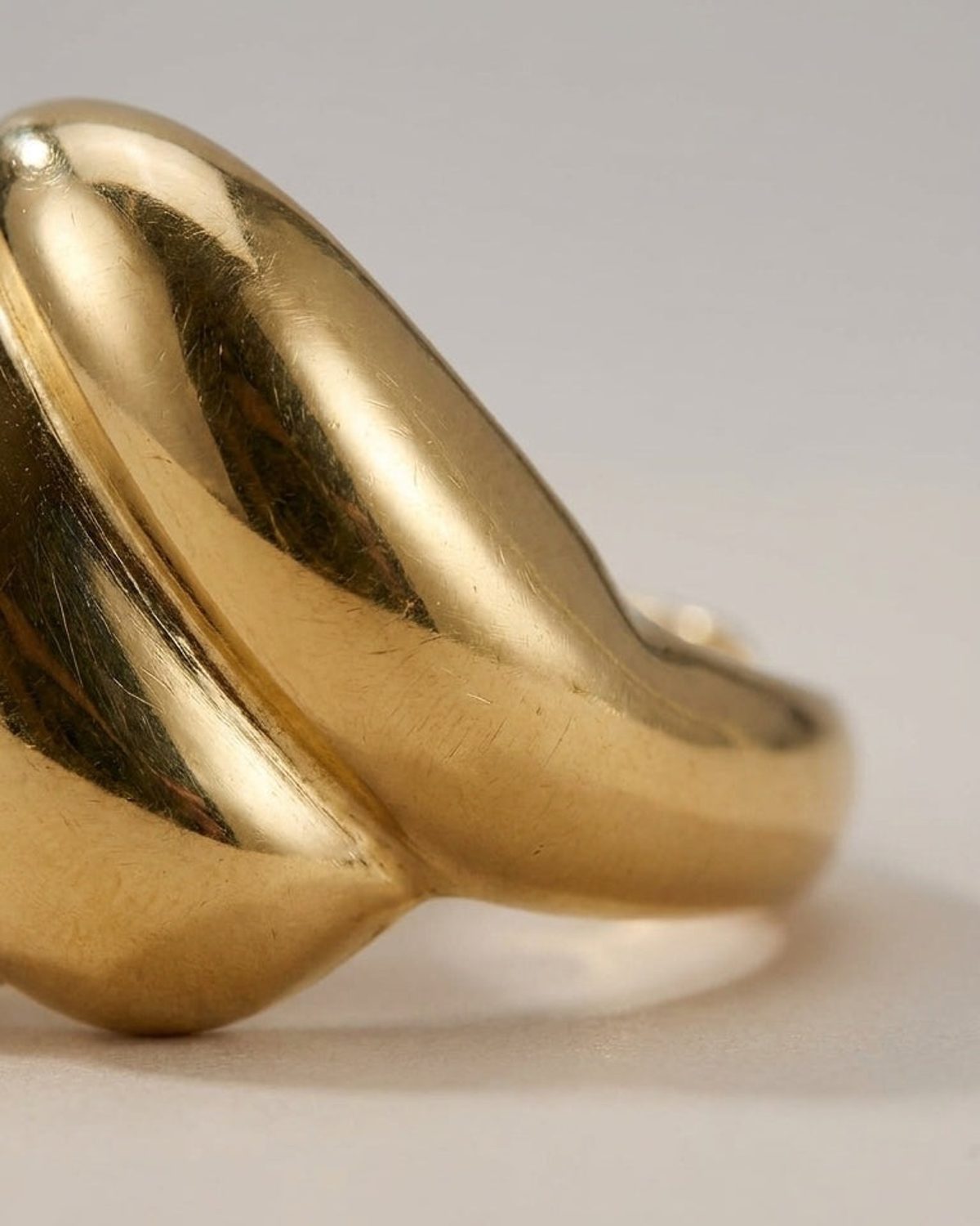 Gold statement ring with a polished, sculptural, bubble-like dome shape.