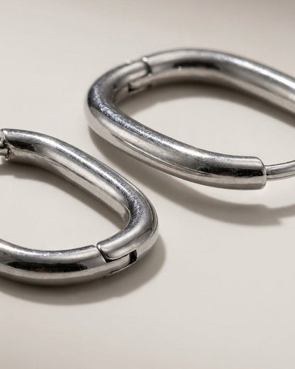 Silver hoop earrings by House of Lily featuring a chunky, minimalist oval design with a smooth, polished finish.