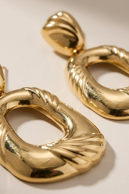 Gold-plated drop earrings featuring chunky, textured geometric hoops with ridged fan details.