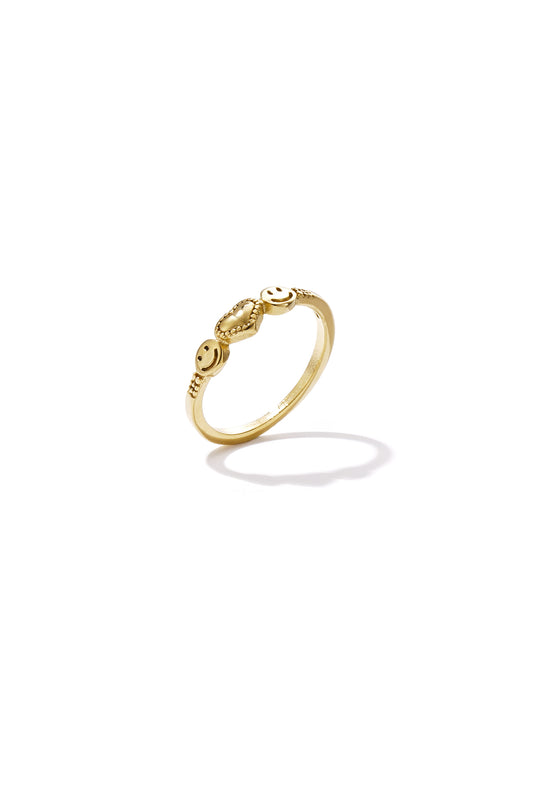 Close-up of a gold-tone ring featuring two smiley faces and a heart design on a white background