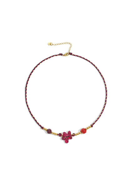 Vibrant red braided flower beaded necklace with gold-tone beads displayed flat on white background