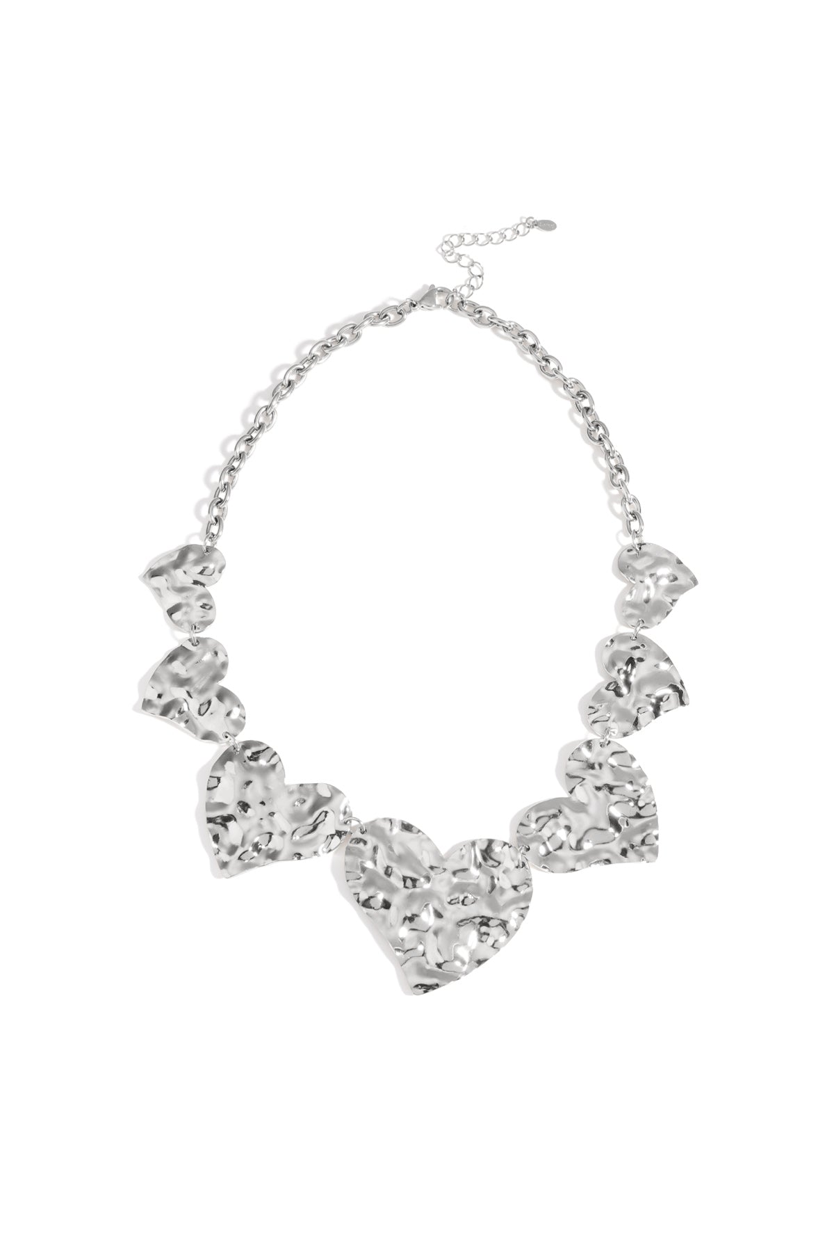 Chunky hammered heart necklace in silver metal with large linked hearts and adjustable chain on white background