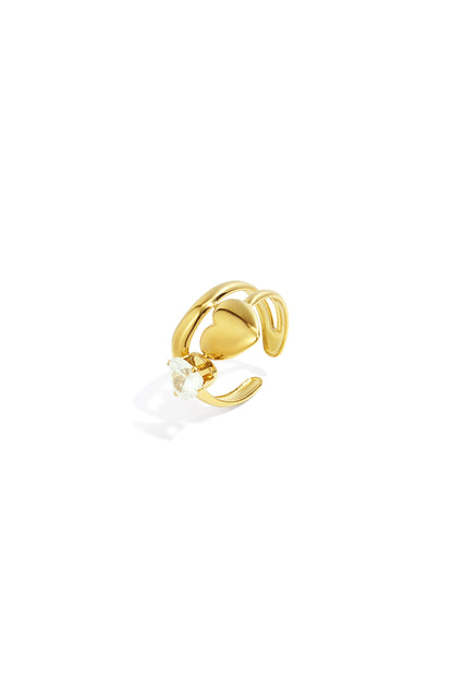 Close-up of a gold adjustable ring with a heart and clear gemstone on white background