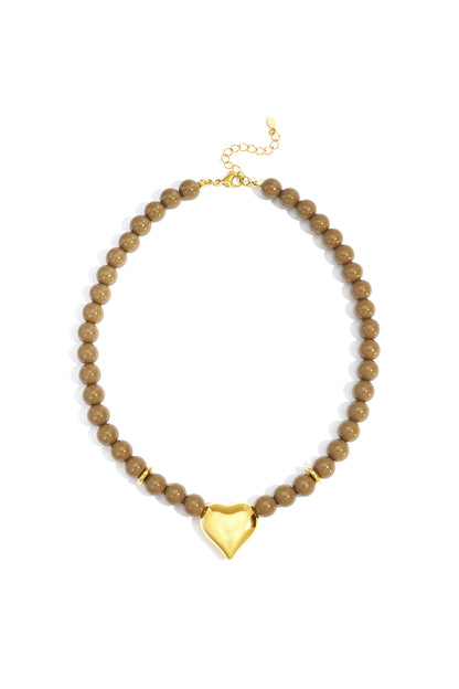 Glossy olive-colored acrylic beaded necklace with gold heart pendant and gold lobster clasp displayed on white background