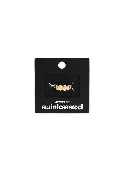 Little Heart Stacker ring in gold-tone stainless steel, featuring a dainty row of small hearts on a black display card.