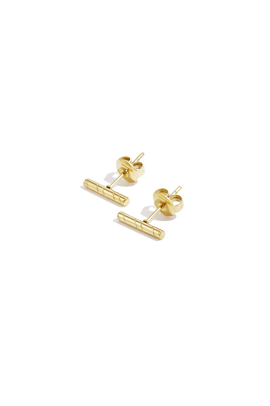 Gold minimalist bar stud earrings with diagonal line pattern on white background