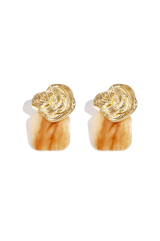 Pair of gold textured stud earrings with caramel-colored acrylic square base on white background