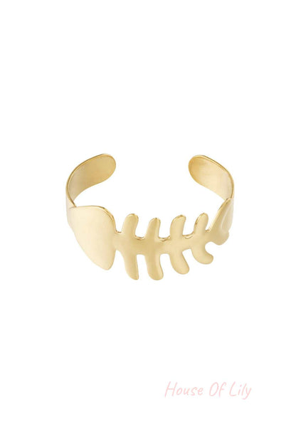 Gold fishbone shaped open cuff bangle bracelet isolated on white background