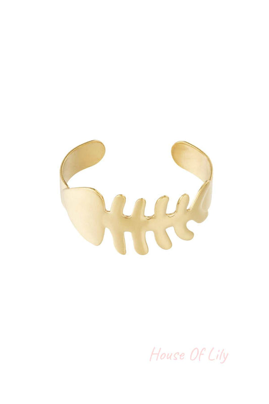 Gold fishbone shaped open cuff bangle bracelet isolated on white background