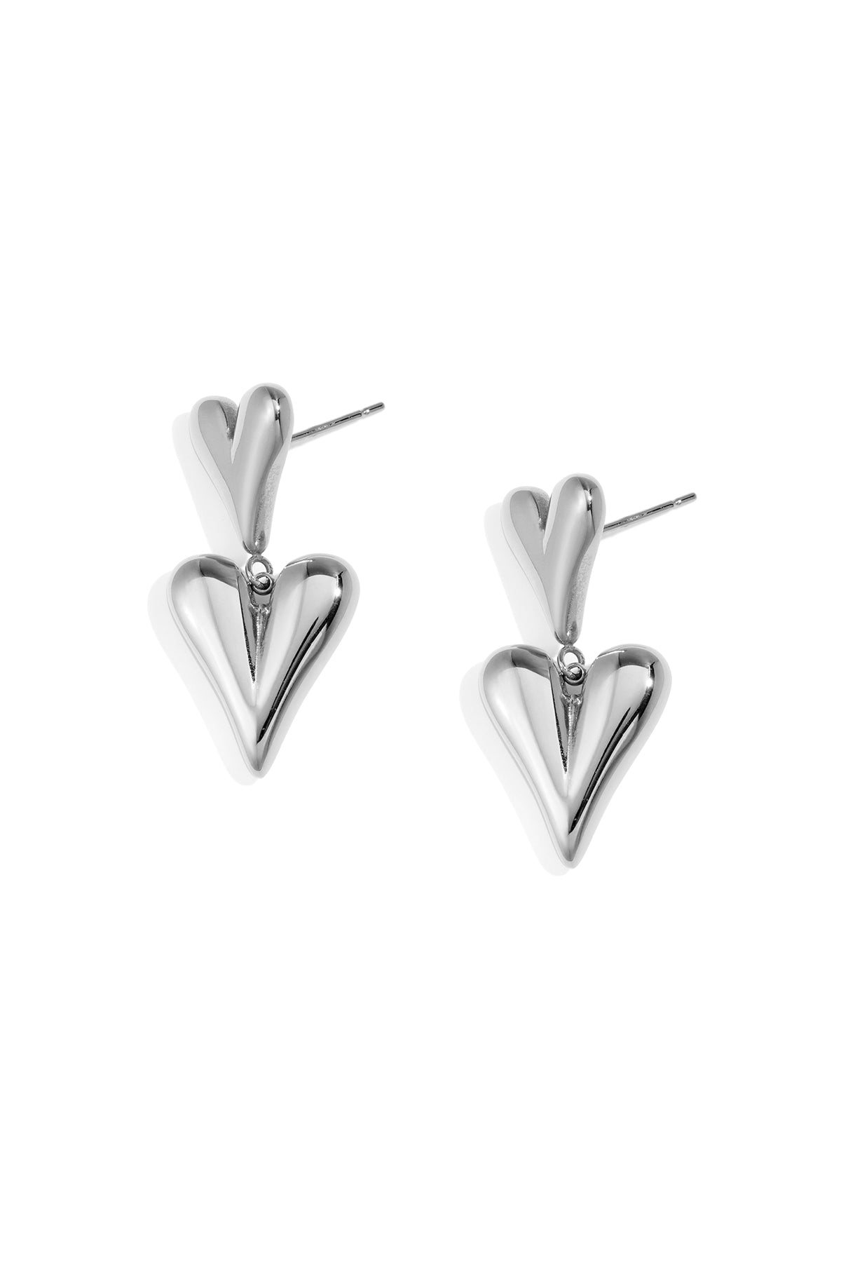 Pair of chunky double heart drop earrings in silver metal with post backs on white background