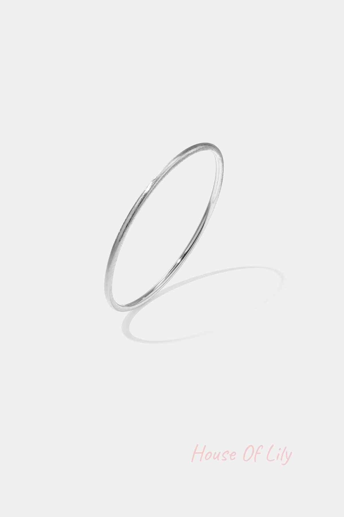Minimalist silver 3mm circle bangle bracelet on white background