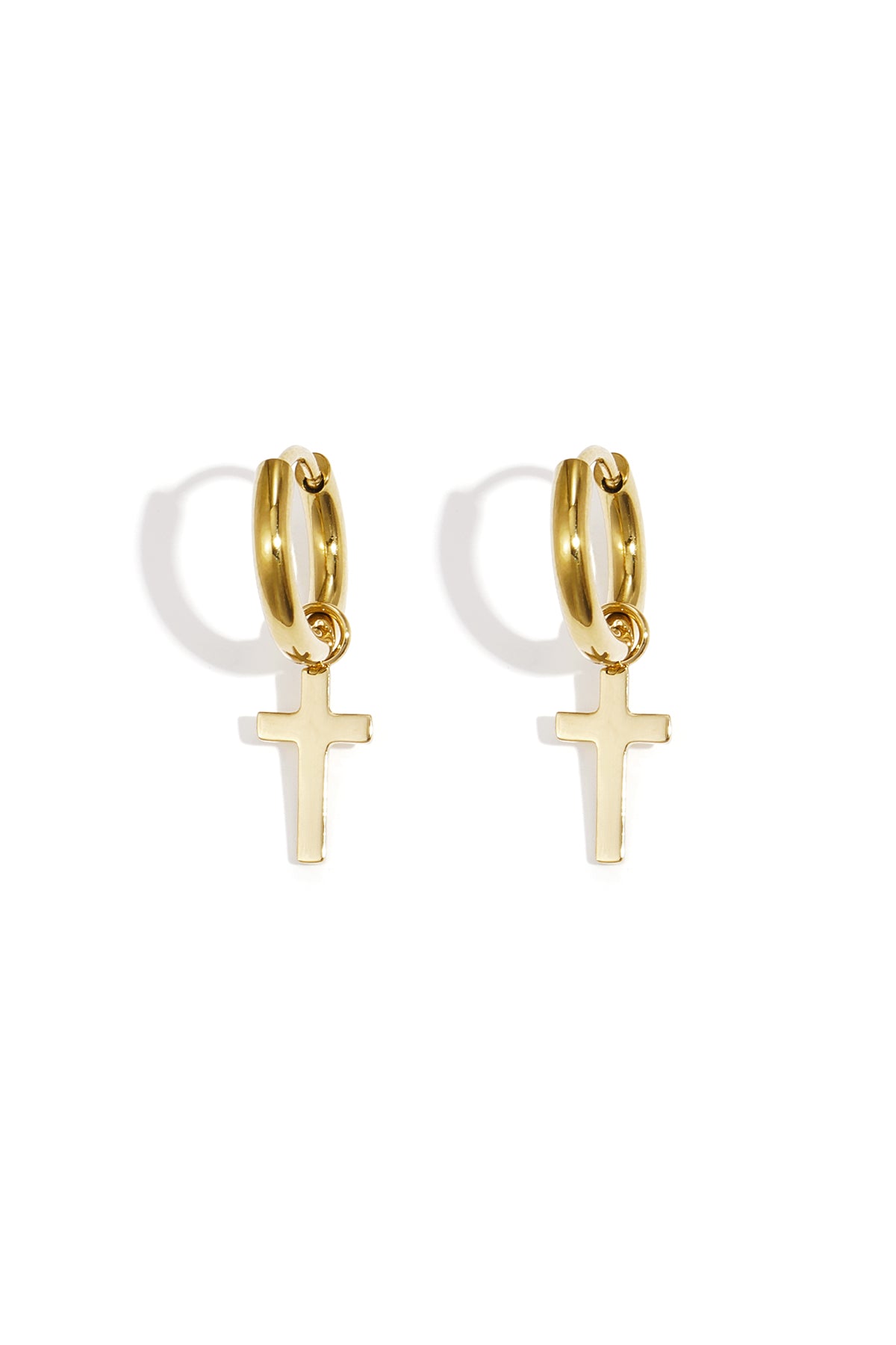 Pair of gold hoop earrings featuring delicate dangling cross pendants on a white background