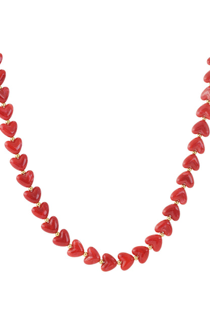 Coral pink marbled heart bead necklace with gold spacers on white background