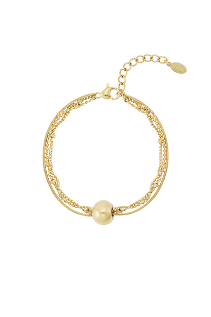 Gold toned multi-chain bracelet with a smooth round sphere charm and adjustable lobster clasp closure on white background