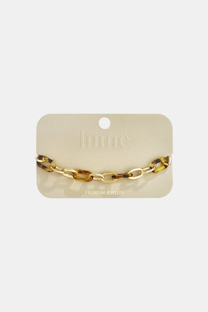 Wild Cat Chain Link bracelet featuring alternating gold and tortoiseshell-patterned resin oval links on a display card.