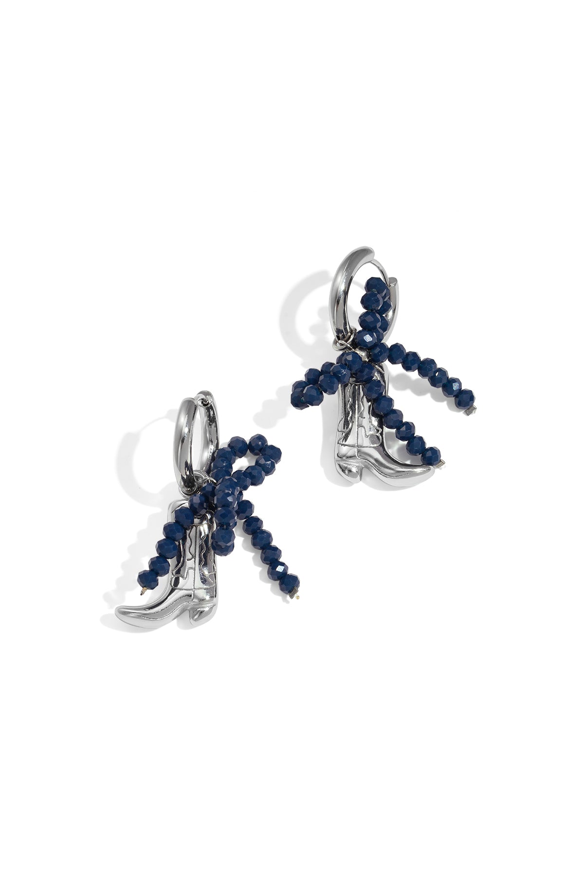 Silver-tone cowboy boot drop earrings with a deep navy blue beaded bow detail