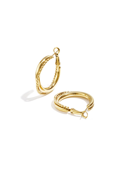 Gold twisted double hoop earrings with smooth and textured finishes, shown on white background.