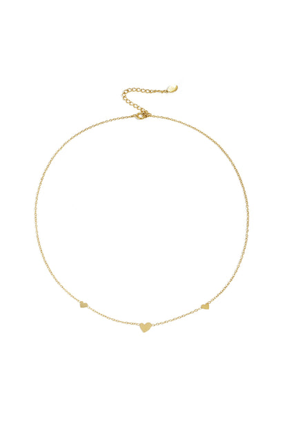 Gold heart charm chain necklace on white background